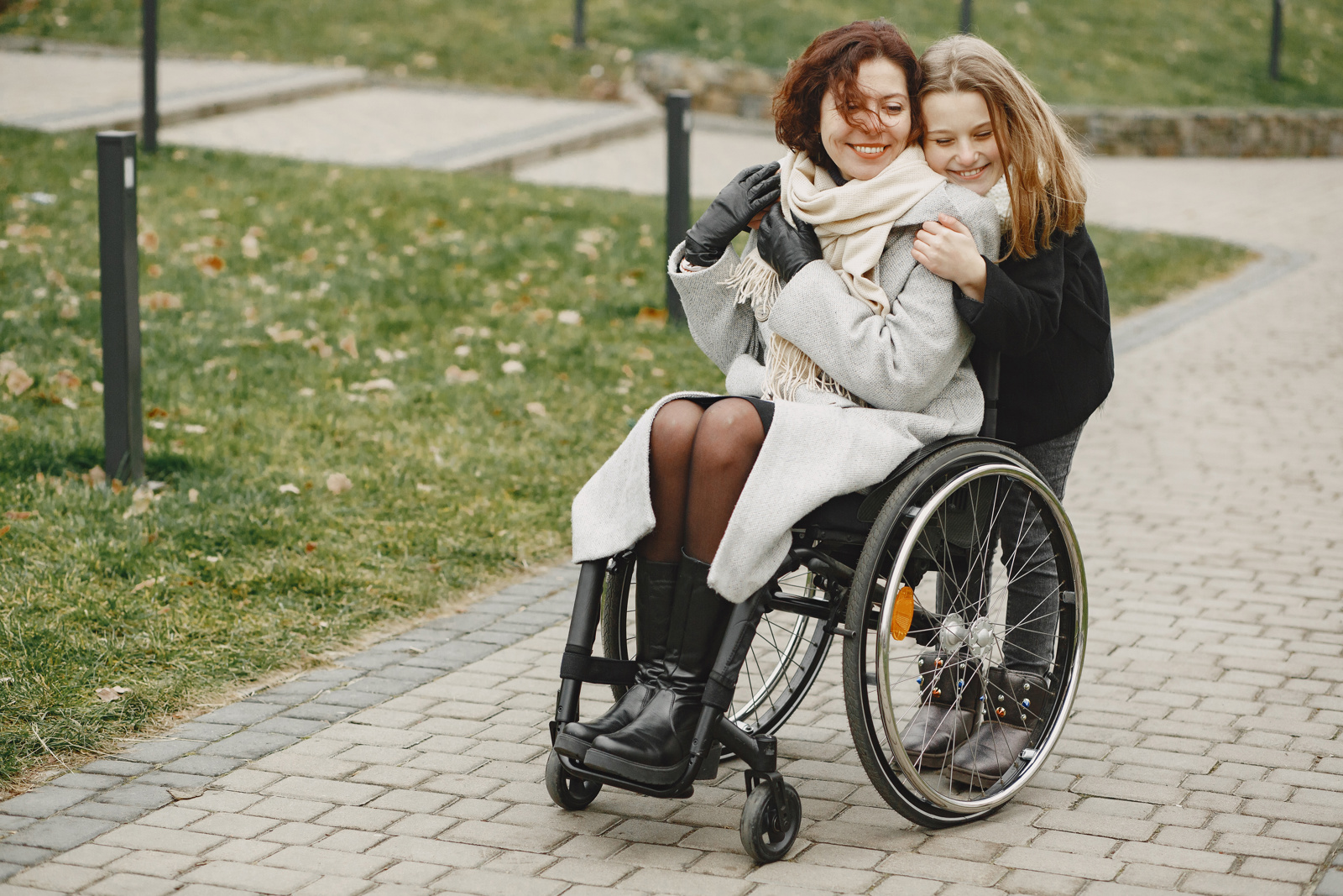 Disabled Woman Wheelchair With Daughter Family Walking Outside Park